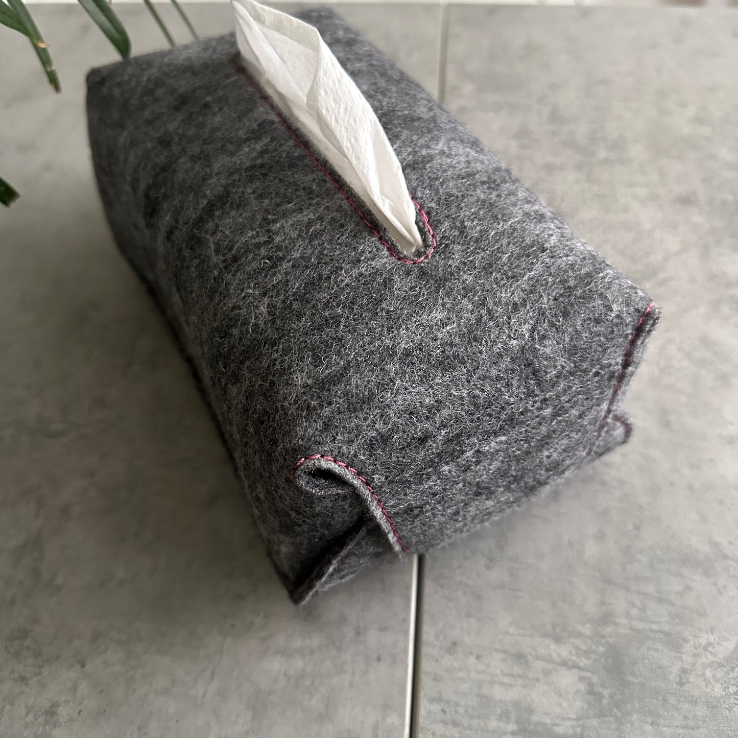 Gray textured tissue holder with pink stitching